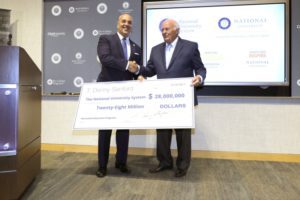T. Denny Sanford presents a check for $28 million to Michael Cunningham, chancellor of National University System in 2017