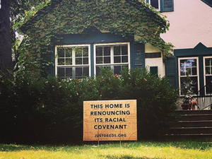 A house in Minneapolis displays a sign denouncing racial covenants which reads, "This home is renouncing its racial covenant."
